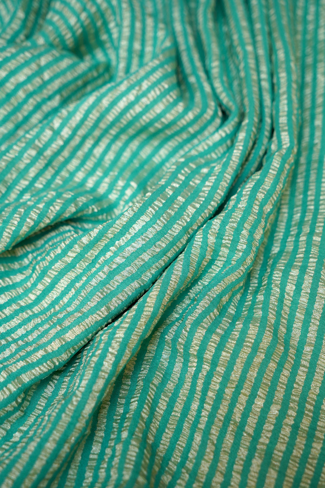 Refreshing Aqua Green Muga Georgette Saree with Zari Stripes