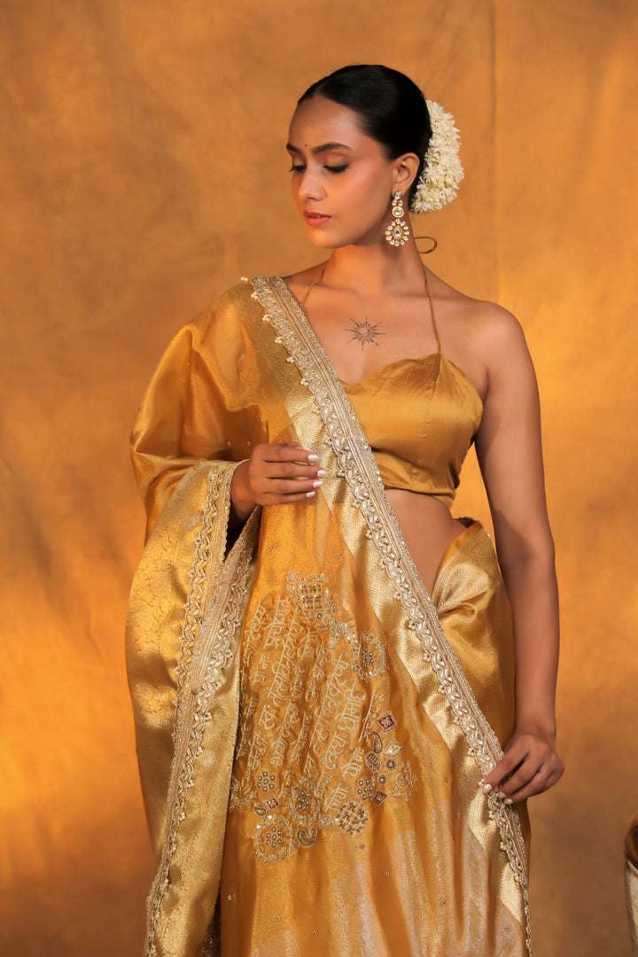 golden pure tissue silk gayatri mantra written with baarat inspired pallu scallop lace border closeup view 1